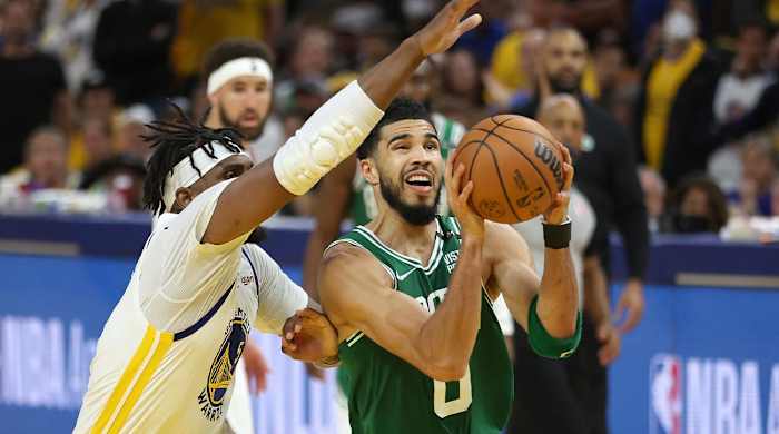 Boston Celtics forward Jayson Tatum (0) drives to the basket against Golden State Warriors center Kevon Looney during the second half of Game 1 of basketball’s NBA Finals in San Francisco, Thursday, June 2, 2022.